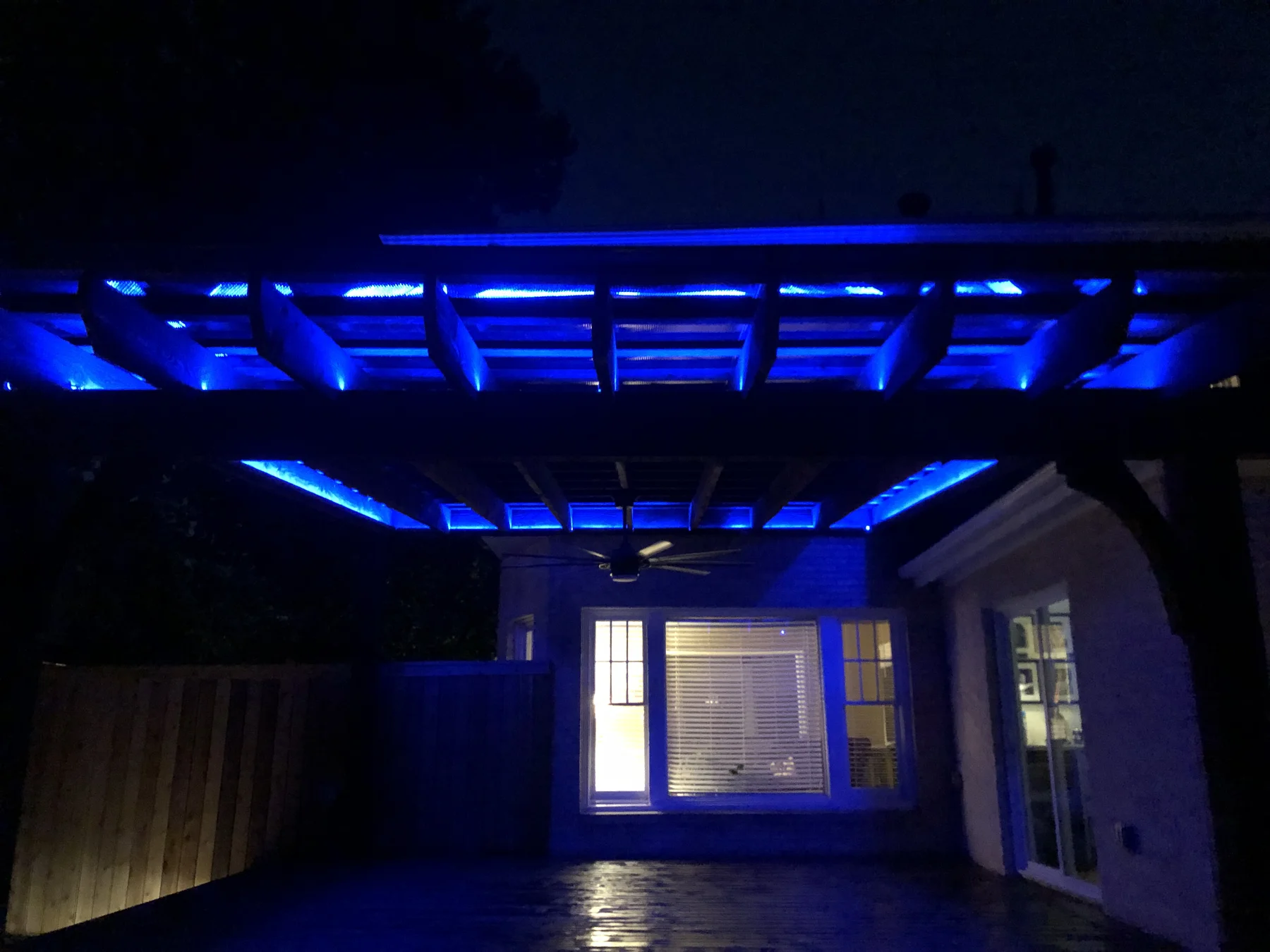 Blue LED strip lights running the full length of every joist — Pergola Jack